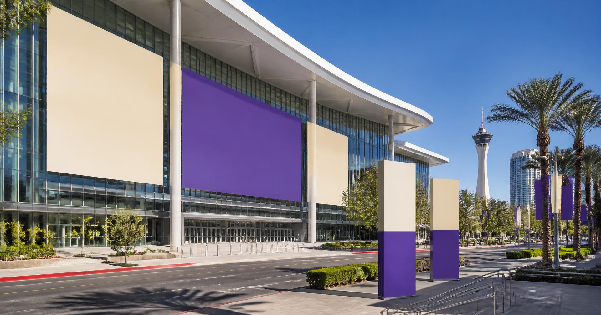 Convention center exterior with oversized event banner panels and wayfinding pylons