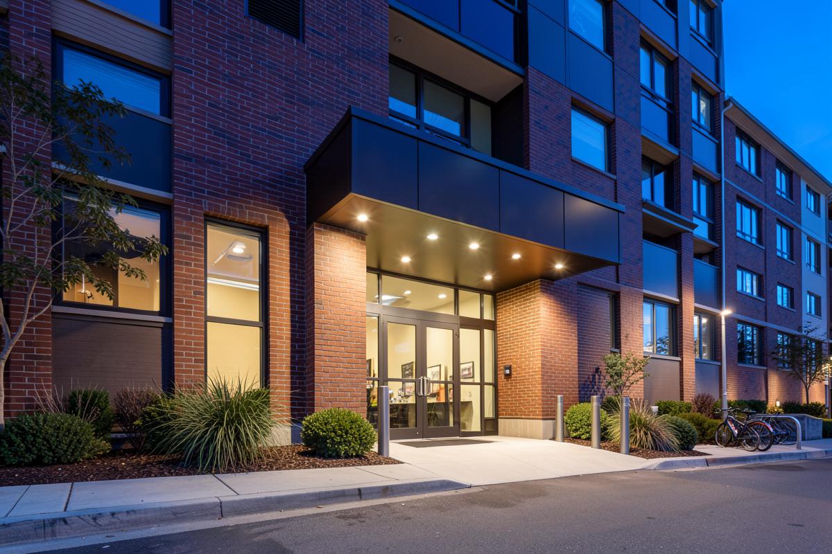 Building entrance at blue hour with illuminated canopy